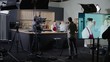 © supamotion - WIDE Behind the scenes of studio set, makeup artist make corrections during shooting television cooking show featuring celebrity chef, professional TV production