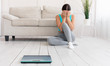 © Prostock-studio - Girl Crying Sitting Near Scales Gaining Excess Weight At Home