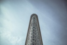 Low Angle View Of Flatiron Building Against Cloudy Sky