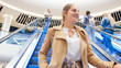 © Kyrylo Ryzhov - Portrait of beautiful smiling young woman riding on escalator in shopping mall