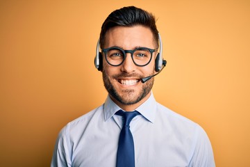 Young business operator man wearing customer service headset from call center with a happy and cool smile on face. Lucky person.