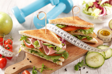 Wall Mural - club sandwich with fresh vegetable and meter tape- diet food concept