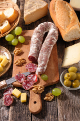 Canvas Print - sausage, cheese and bread on wooden board