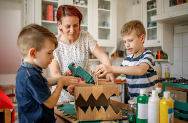 Wall Mural - Mother helping kids to finish quarantine project