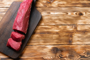 Wall Mural - Slices raw meat fillet on wooden board