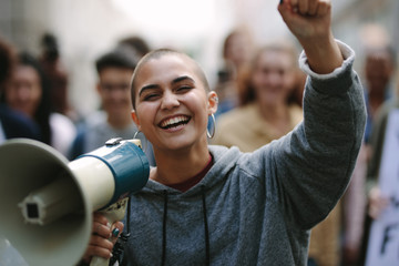 Wall Mural - Woman in a street demonstration with a megaphone