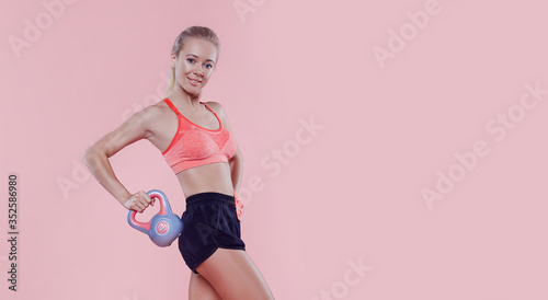 Cuadros en Lienzo Sexy sporty lady with weight studio portrait on pink background, fitness sporty woman beautiful fit girl, weight loss