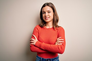 Young blonde girl wearing casual red sweater over isolated background happy face smiling with crossed arms looking at the camera. Positive person.