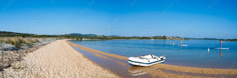 Inflatable Boat Moored On Lakeshore Against Clear Blue Sky - obrazy, fototapety, plakaty 