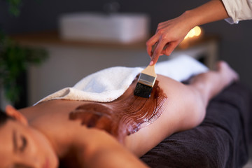 Canvas Print - Relaxed woman receiving a chocolate back massage