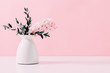 Pink hyacinth, eucalyptus on pink wall background. Spring flower hyacinth in vase on pink background.