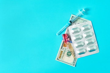 Wall Mural - Banknote of 100 usd, pills, red vaccine and syringe on green background. Corruption in medicine. Purchasing medications in pharmacy. Drugs donations. Payment for treatment. Health сare concept