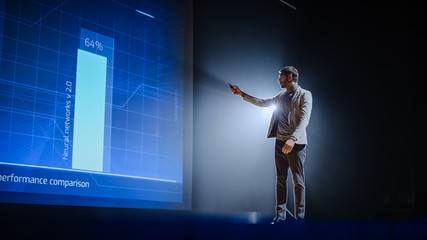 Aufkleber - On-Stage: Handsome Speaker Does Presentation, New Product Release, Shows Infographics, Statistic Animation on Big Screen. Auditorium Hall Live Event, Start-up Conference, Device Presentation.