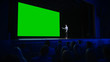 © Gorodenkoff - Inspirational Speaker Does Presentation New Product to Audience, Behind Her Movie Theater with Green Screen, Mock-up, Chroma Key. Female CEO Shows Leadership on Business Live Event or Device Reveal