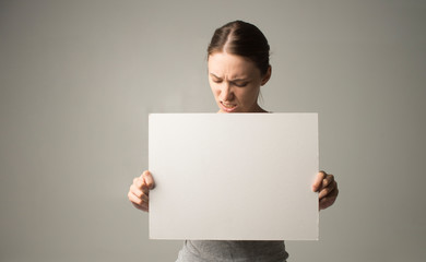 woman holding a sheet of paper in her hand