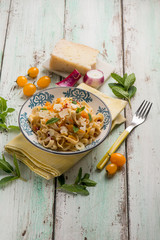 Wall Mural - tagliatelle pasta with yellow fresh tomatoes sheep cheese and mint leaves