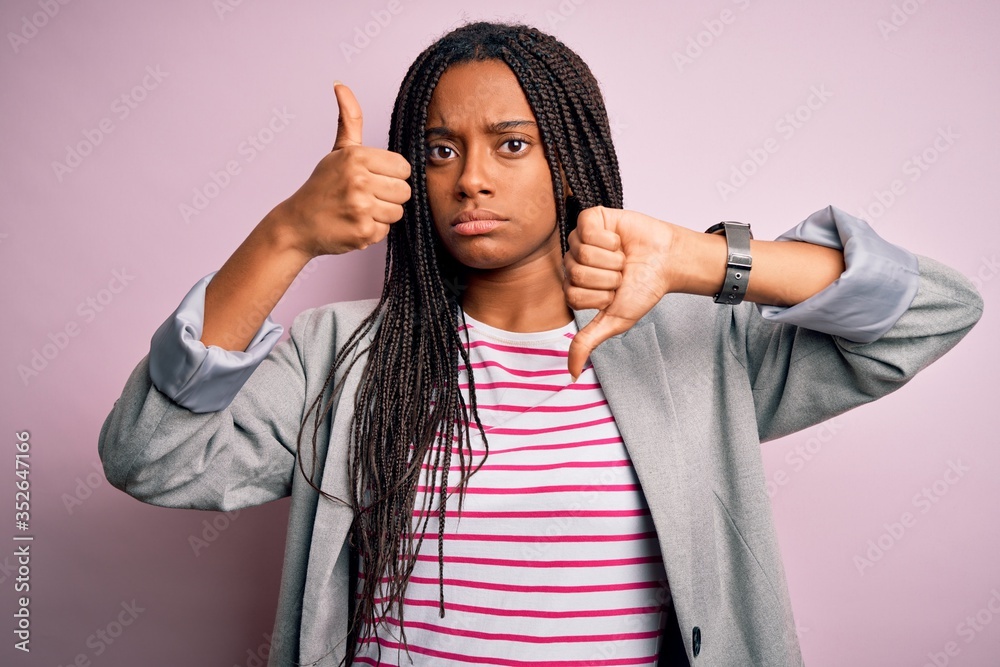 Young african american business woman standing over pink isolated ...