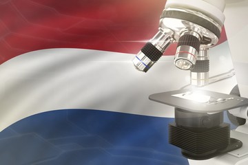 Netherlands science development concept - microscope on flag background. Research in medicine or healthcare 3D illustration of object