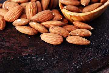 Canvas Print - Almonds on a rustic background and almond in bowl.