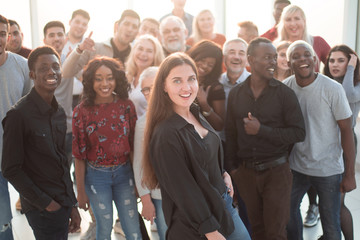 Wall Mural - confident young woman standing in front of a group of her friends