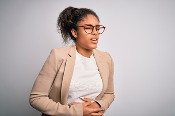 Poster - Beautiful african american businesswoman wearing jacket and glasses over white background with hand on stomach because nausea, painful disease feeling unwell. Ache concept.