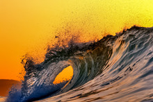 A Perfect Hole Through A Wave During A Glorious Japanese Sunrise In Deep Water, The Wave Looks Like It Is Breaking Round A Bend & There Is A Small Headland In The Background
