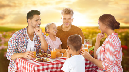 Poster - Happy family having picnic at table in garden