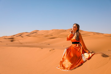 Wall Mural - A girl in a beautiful Moroccan dress. Merzouga Morocco.