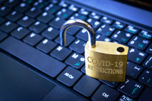 Unlocking COVID-19 Coronavirus Restrictions In The New Normal As Illustrated By The Unlocked Padlock.