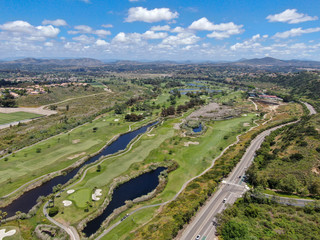 Aerial view of a green golf course during sunny day in South California. USA