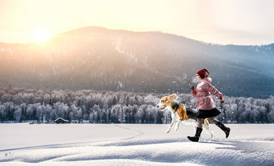 Girl walking with a dog in winter