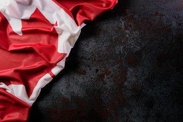 National flag of Canada on dark stone background, beautiful colored with cloth texture and copy space.