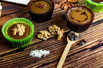 Chocolate Brownie Cake in Paper Cups Decorated with components for making cakes placed on wooden floors