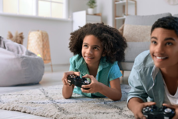 Poster - African-American teenagers playing video game at home