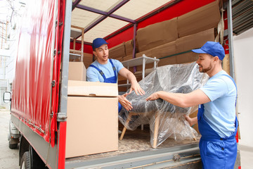 Sticker - Loaders taking furniture from truck outdoors