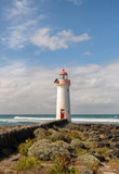Fototapeta  - Port Fairy Lighthouse, built in 1859 is a magnificent red and white sentinel that stands on the easternmost tip of Griffiths Island