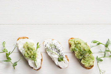 Healthy sandwiches with avocado , cream cheese and micro green. Vegan sandwiches, vegan food, healthy eating. Template with space for text , white background