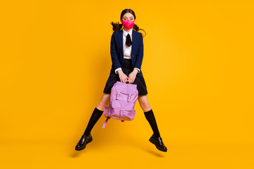 Sticker - Full length photo of high school teenager girl jump hold backpack bag wear black blazer jacket long socks skirt medical mask isolated over bright shine color background