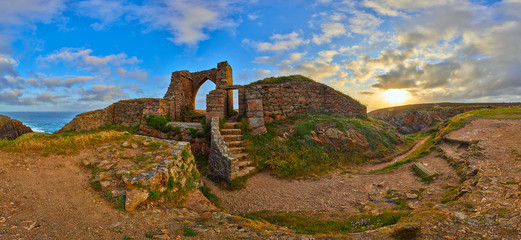 Panoramic image of Grosnez Castle keep constructed circa 1330 and located in the North West corner of Jersey early morning with the sea in the background and blue skys.  Jersey, Channel Islands, UK