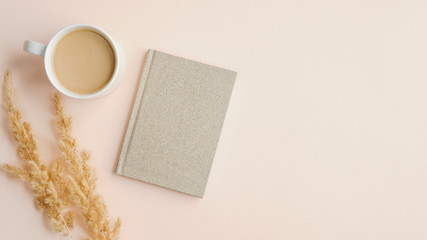 Fototapete - Flat lay, top view home office desk table with cup of coffee, paper notebook and dry flowers on beige background. Elegant feminine workspace, minimalistic style