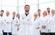 © ASDF - confident scientific leader standing in front of a team of young scientists.