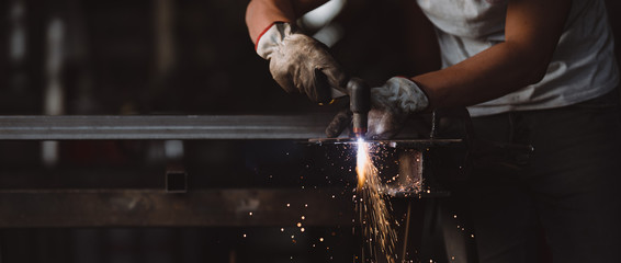 Professional welder at work in his factory