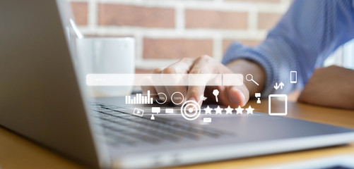 Wall Mural - close up man hand type on keyboard laptop to use search engine optimization (seo) tools for finding 