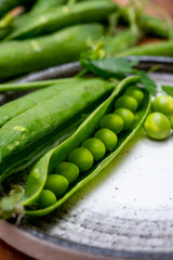 New harvest of ripe green peas legumes