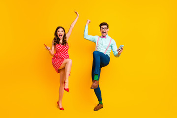 Canvas Print - Full length photo attractive lady handsome guy couple hold telephones win lottery online scream achievement wear red dotted dress shirt bowtie retro clothes isolated yellow color background