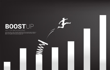 silhouette of businessman jump to higher column of graph with springboard. concept of boost and grow