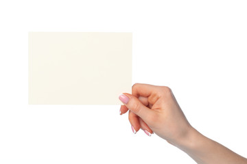 Woman's hand holding blank white sheet of paper isolated on white