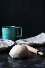 Dough ,making dough with flour on a black background, bread and pizza dough