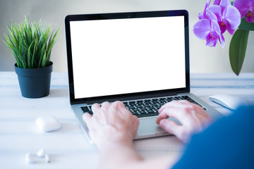 Home working concept, Laptop computer white blank screen on work table front view. Copy space, home office workspace concept, laptop mockup.