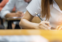 High School,university Student Study.hands Holding Pencil Writing Paper Answer Sheet.sitting Lecture Chair Taking Final Exam Attending In Examination Classroom.concept Scholarship For Education Abroad